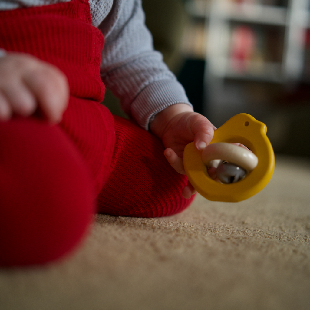 Wooden bird rattle with a bell